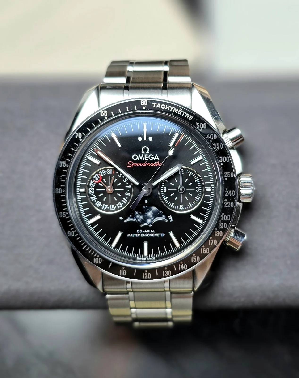 Frontal view of Omega Speedmaster Moonphase 304.30.44.52.01.001 showing the moonphase display and two subdials